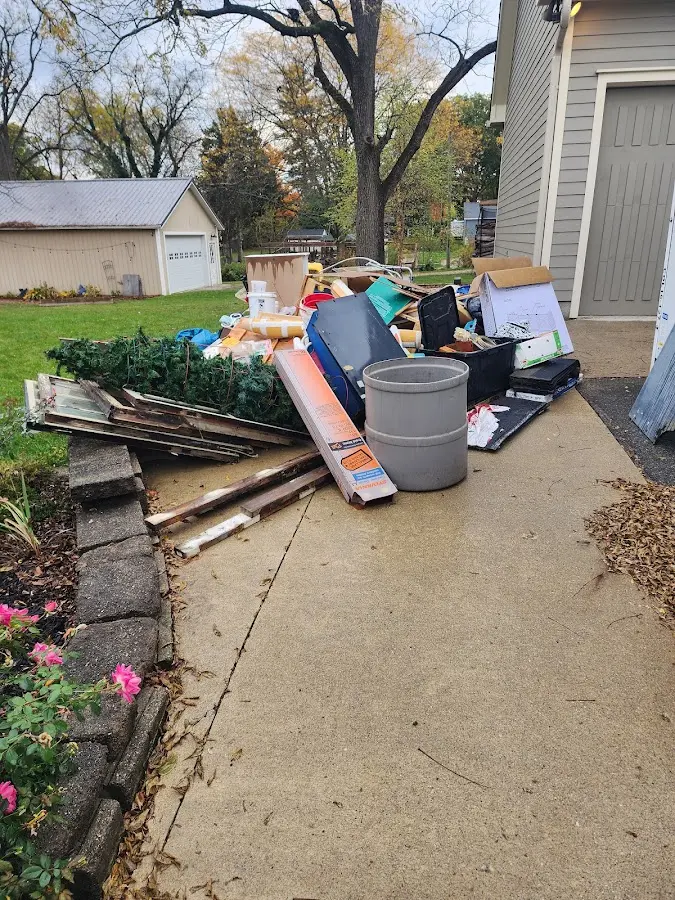 Dumpster being loaded with debris for Commercial Dumpster Rental in Bethel